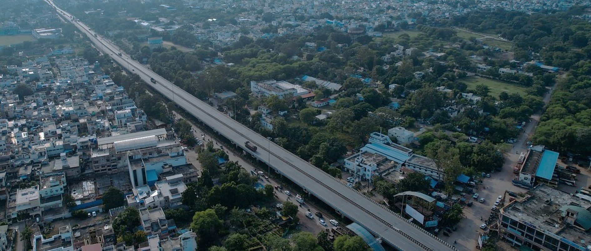 Elevated highway works through a town, seen from a drone